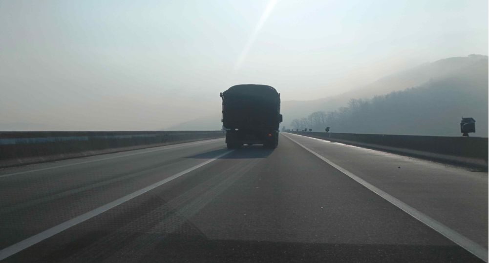 On a bridge in winter · Truck ahead changing from lane 1 to lane 2