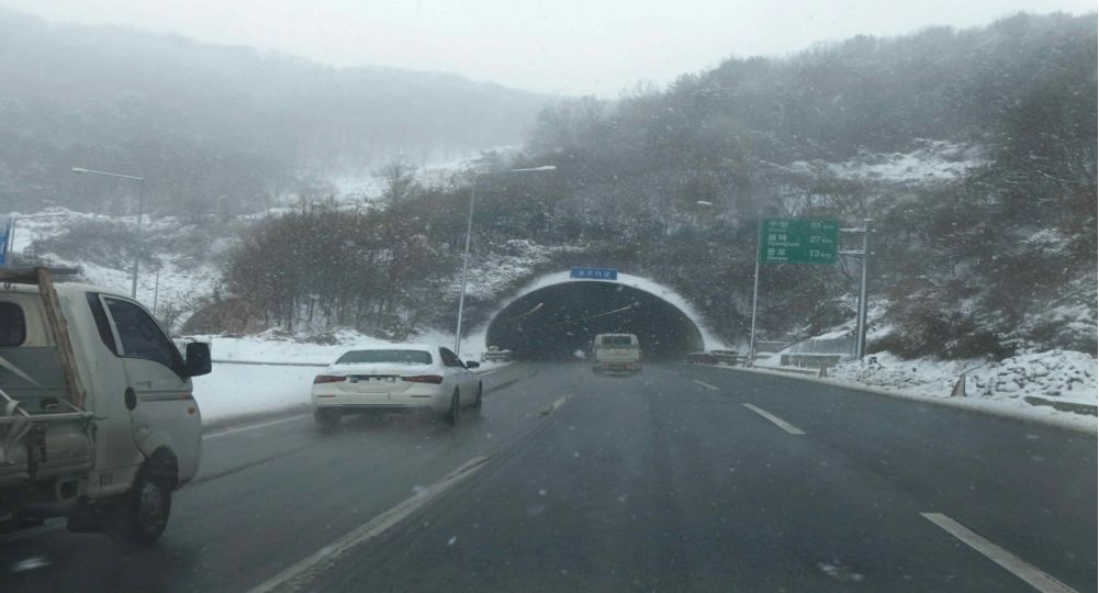 Snow is falling, so the road is slippery · Truck ahead in the same lane moving slowly · About to overtake the truck ahead in lane 2