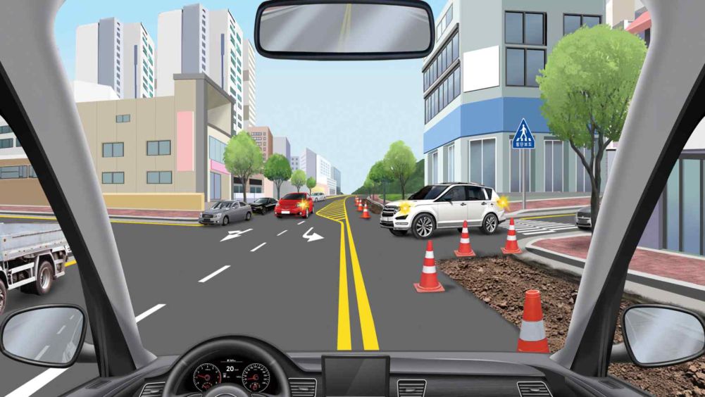Road maintenance in progress · The white car is moving from right to left