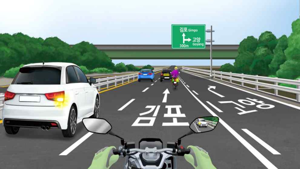 The black car is driving slowly · A motorcycle heading toward Goyang · An entrance/exit 300 m ahead