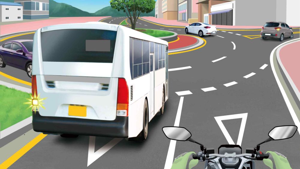 Entering a roundabout · A white bus about to enter the roundabout