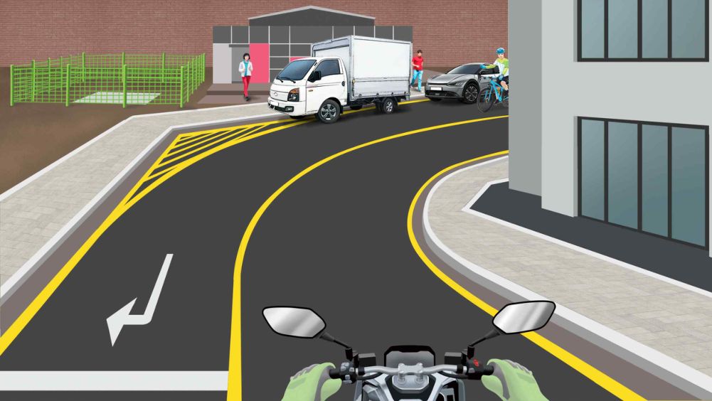 Two vehicles parked on a road curving to the right · A bicycle coming downhill from the opposite side is hidden by a building